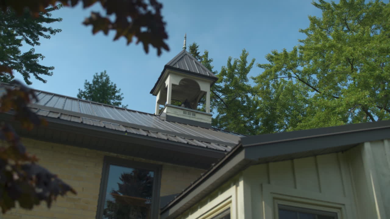 Pan to reveal belfry on top of an old schoolhouse building