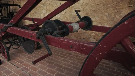 close up of a vintage wooden cart with metal gears in kumrovec, croatia