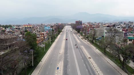 An-aerial-flight-over-the-empty-ring-road-in-the-city-of-Kathmandu,-Nepal