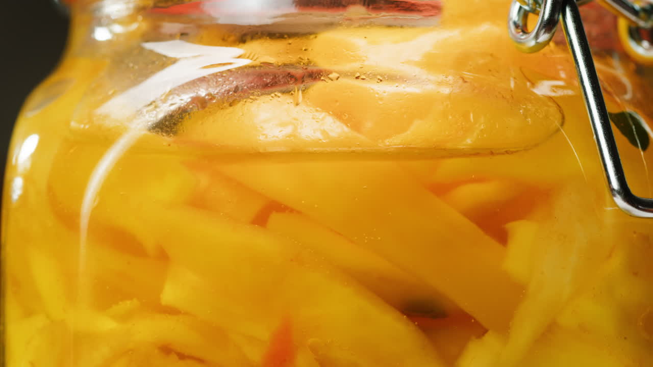 Close-up of fermented yellow cabbage in can. Preservation of vegetables in glass jars. Fermentation preserved vegetables. Sauerkraut with spices.