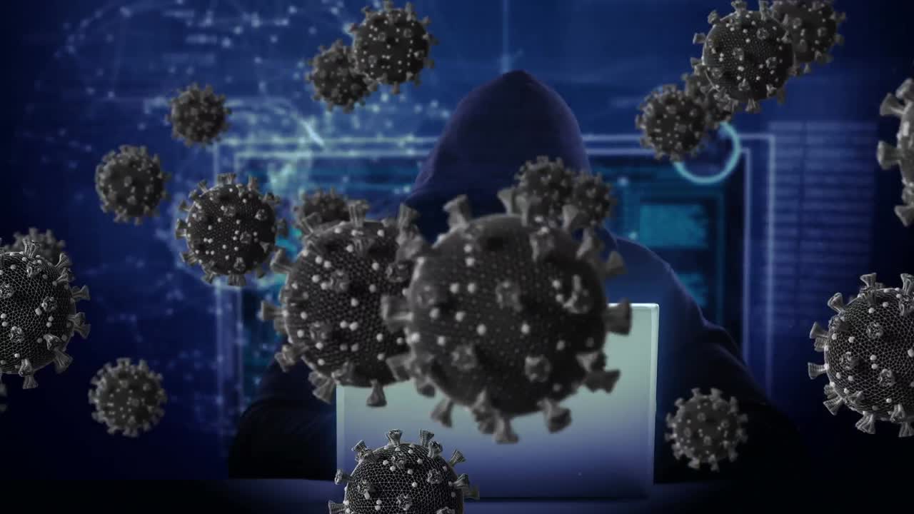 animación de células macro covid19 sobre un hombre con capucha, usando una computadora portátil