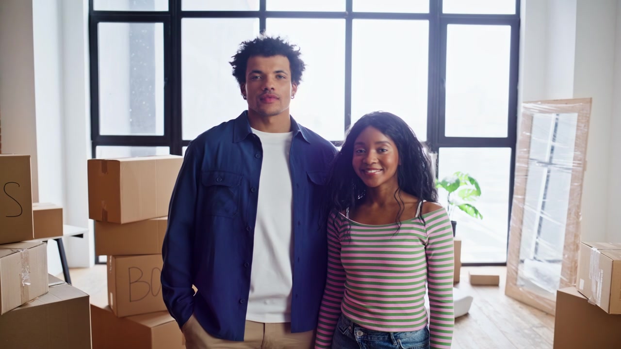 Couple posing new home cardboard boxes closeup. Boyfriend hugging girlfriend