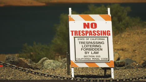 no tresspassing sign sits roadside warning motorists of closed roadway