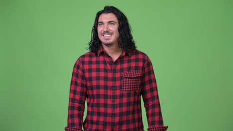 handsome hipster man smiling and thinking