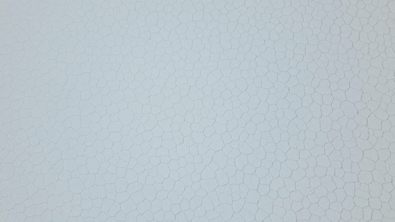 Experience the ethereal beauty of Bolivia's Salar de Uyuni with mesmerizing drone footage showcasing the endless salt flats from above