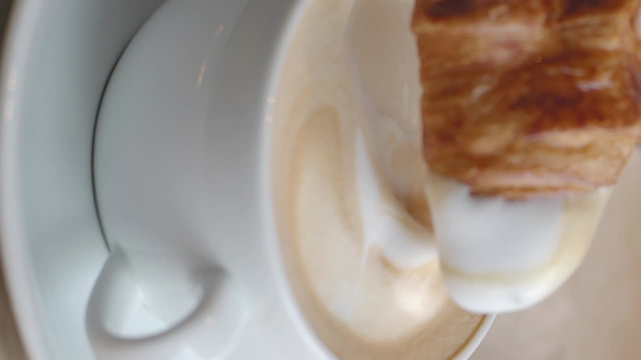 Croissant Dipping into a Latte with Latte Art