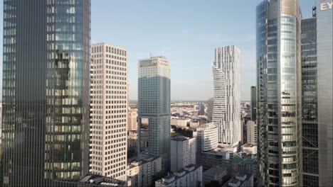 Modern-office-buildings-and-Palace-of-Culture-and-Science-in-Warsaw-city,-Poland,-aerial-view