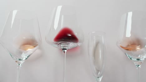 Glasses-with-diverse-types-of-wines-lying-on-grey-surface-with-copy-space