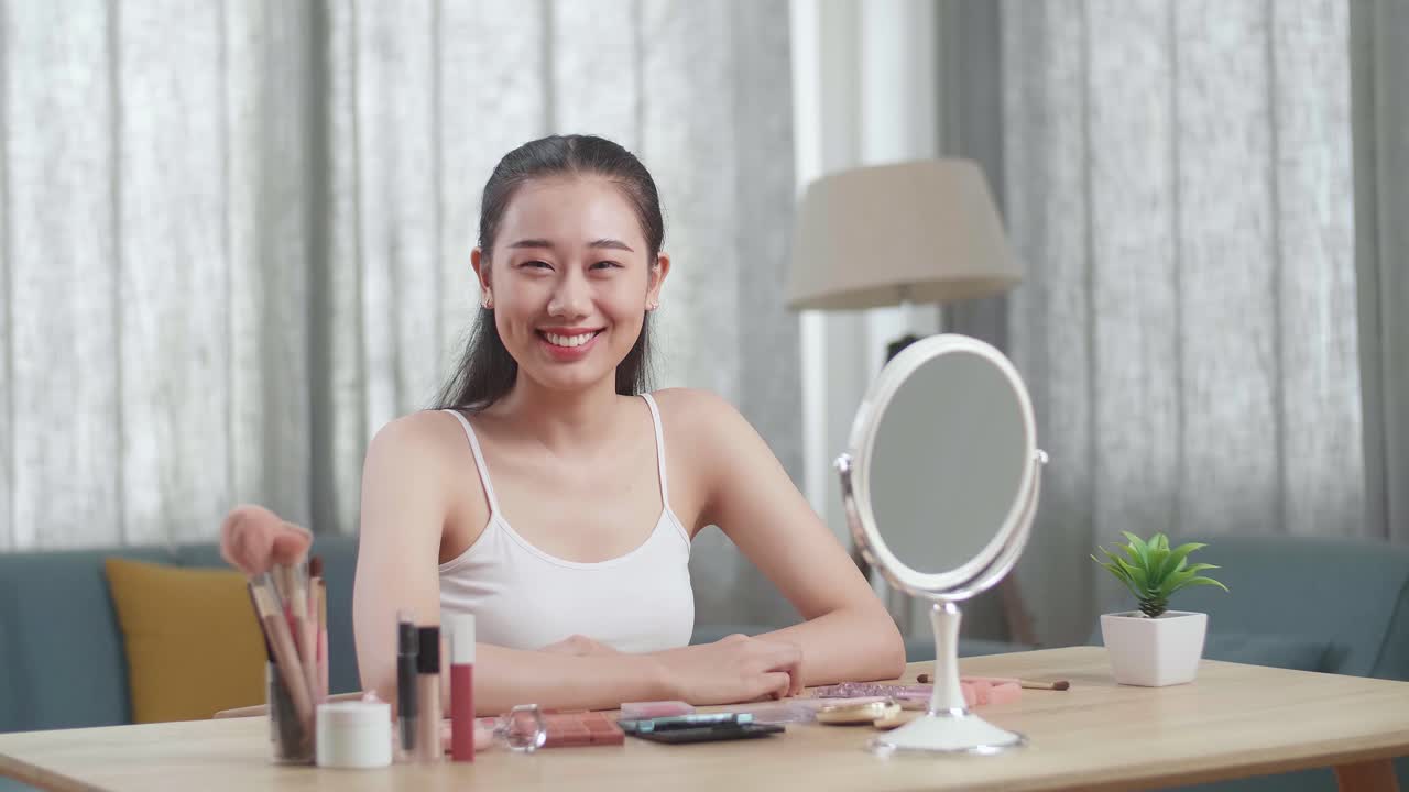 Young woman doing makeup tutorial