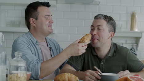 happy gay couple having breakfast
