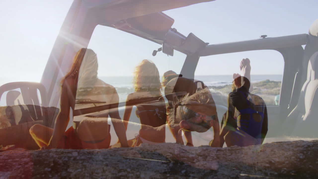 Animation of car interior in sunlight overlaying people at beach view