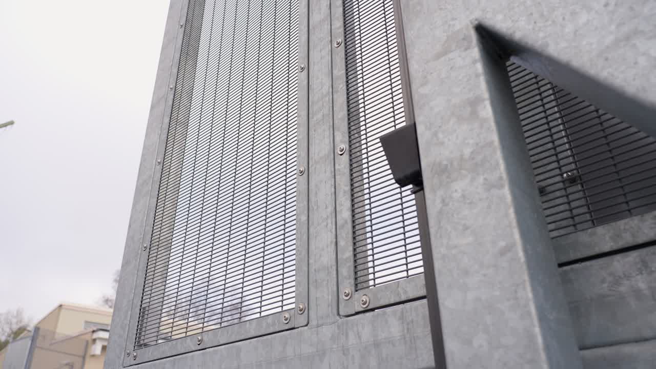 Details of main gate of a prison closing in slow motion