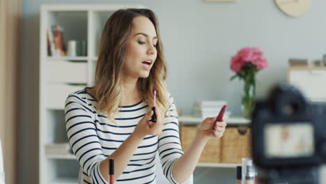 pretty beauty blogger recording a makeup tutorial video and talking about lipglosses 1