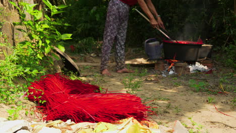 hand dyeing straws for handmade rugs and carpets in large pot