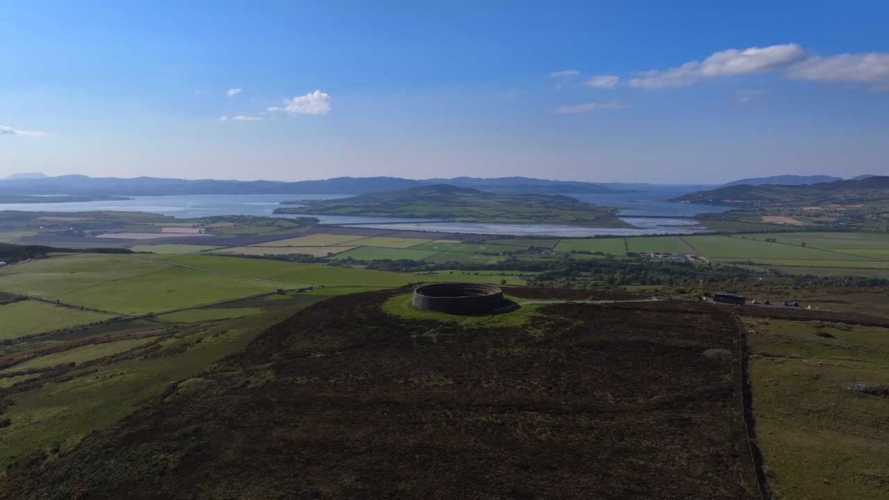 Grianan of Aileach, County Donegal, Ireland, June 2023. Drone wide counter clockwise orbit around the Iconic Gaelic Hillfort surrounded by stunning countryside with Lough Swilly in the distance.