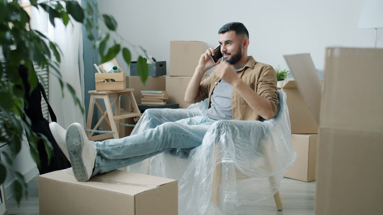 Man Talking on Phone During House Move