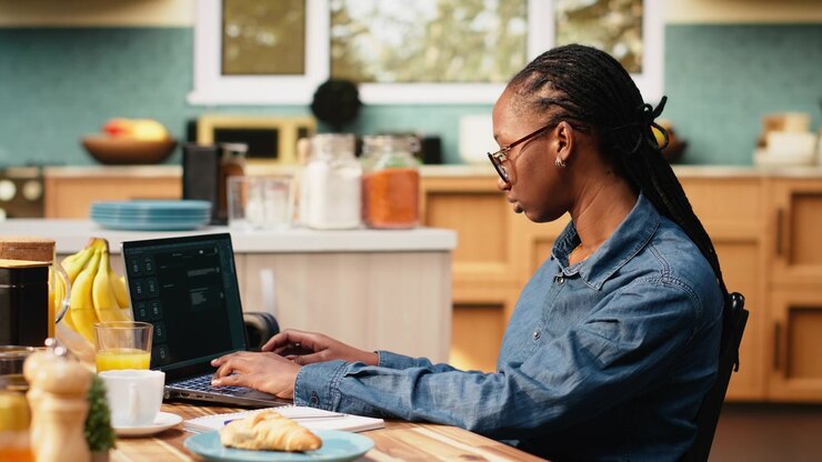 Young woman communicating with AI virtual assistant on laptop at home