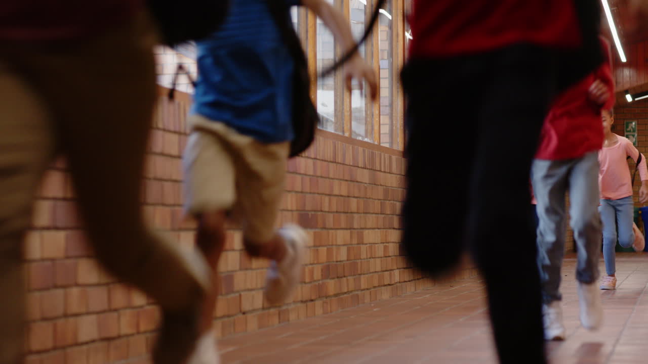 Running in school hallway, group of students enjoying break time together