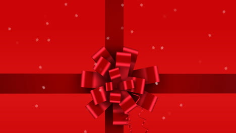 animation of snow falling over ribbon on red background