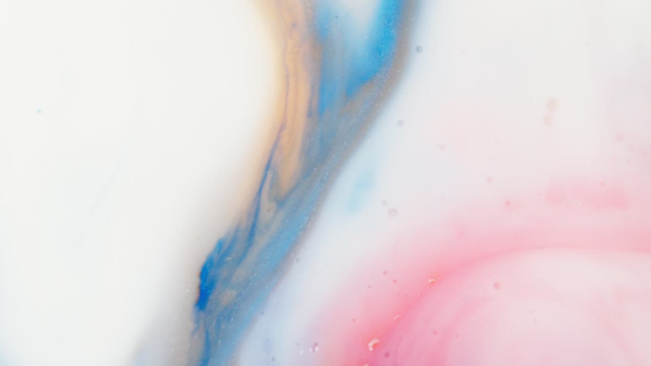 Blue red and orange liquid ink streaks in white color fluid, abstract