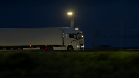 white truck driving on highway at night