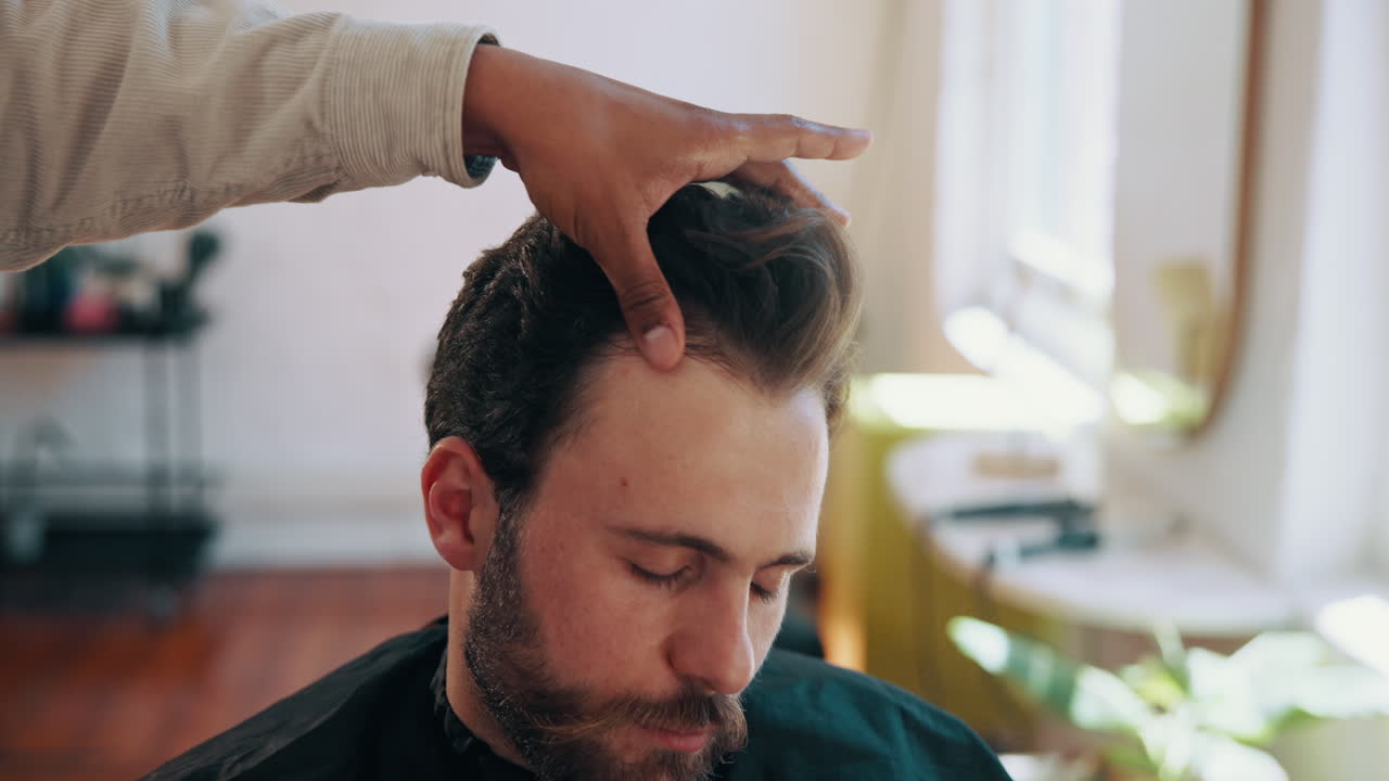 Barber Styling a Man's Hair in a Modern Barbershop