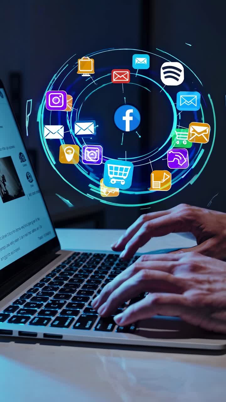 Hands typing on a laptop with colorful social media icons floating above
