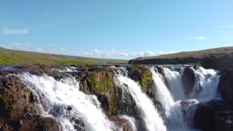 Sunny-spring-day-with-Kolufossar-waterfalls-in-Kolugljúfur,-Iceland,-aerial-pedestal-up-shot