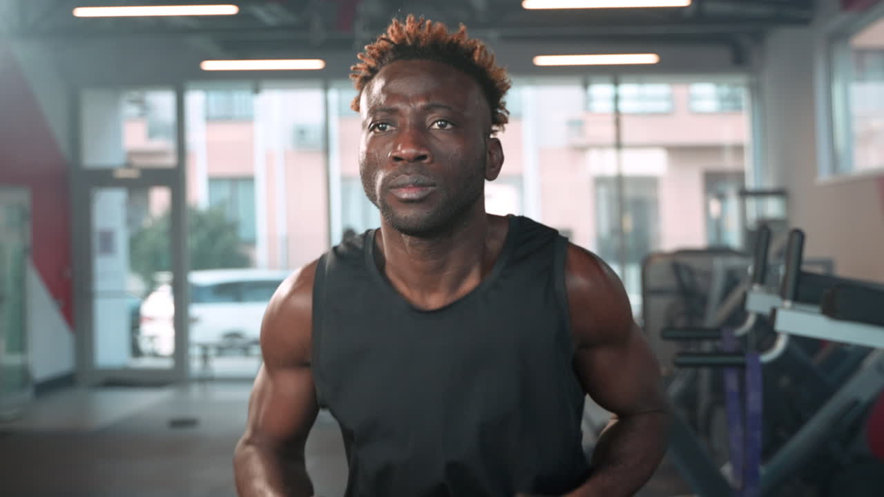 Man Running on Treadmill in Gym