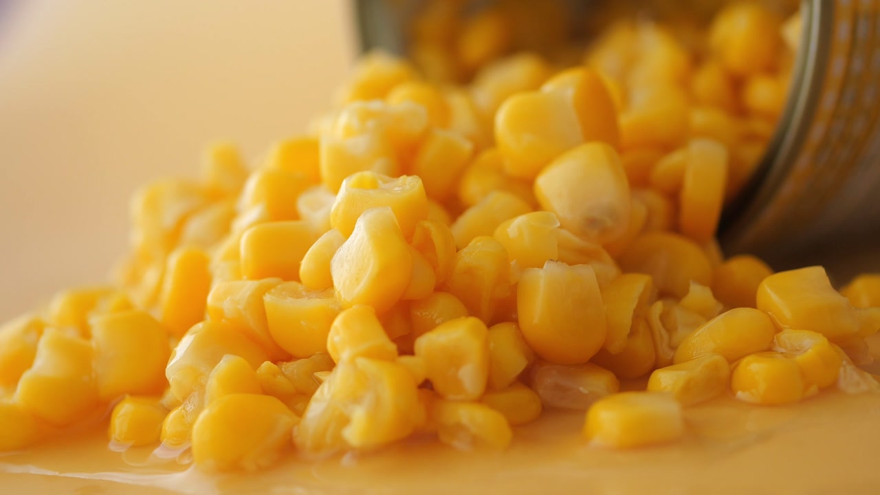 Vibrant Sweet Corn Kernels Spilling from a Can
