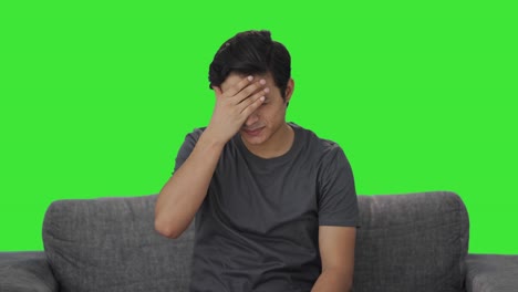 sick indian man suffering from headache green screen