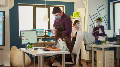 coworkers with protection face masks working together