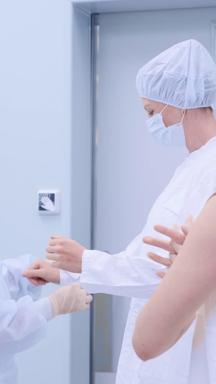 Medical professionals in sterile attire preparing for surgery in a modern healthcare environment