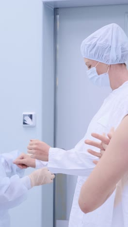 medical professionals in sterile attire preparing for surgery in a modern healthcare environment