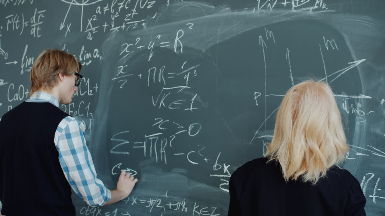 Students working on a chalkboard during a math class.