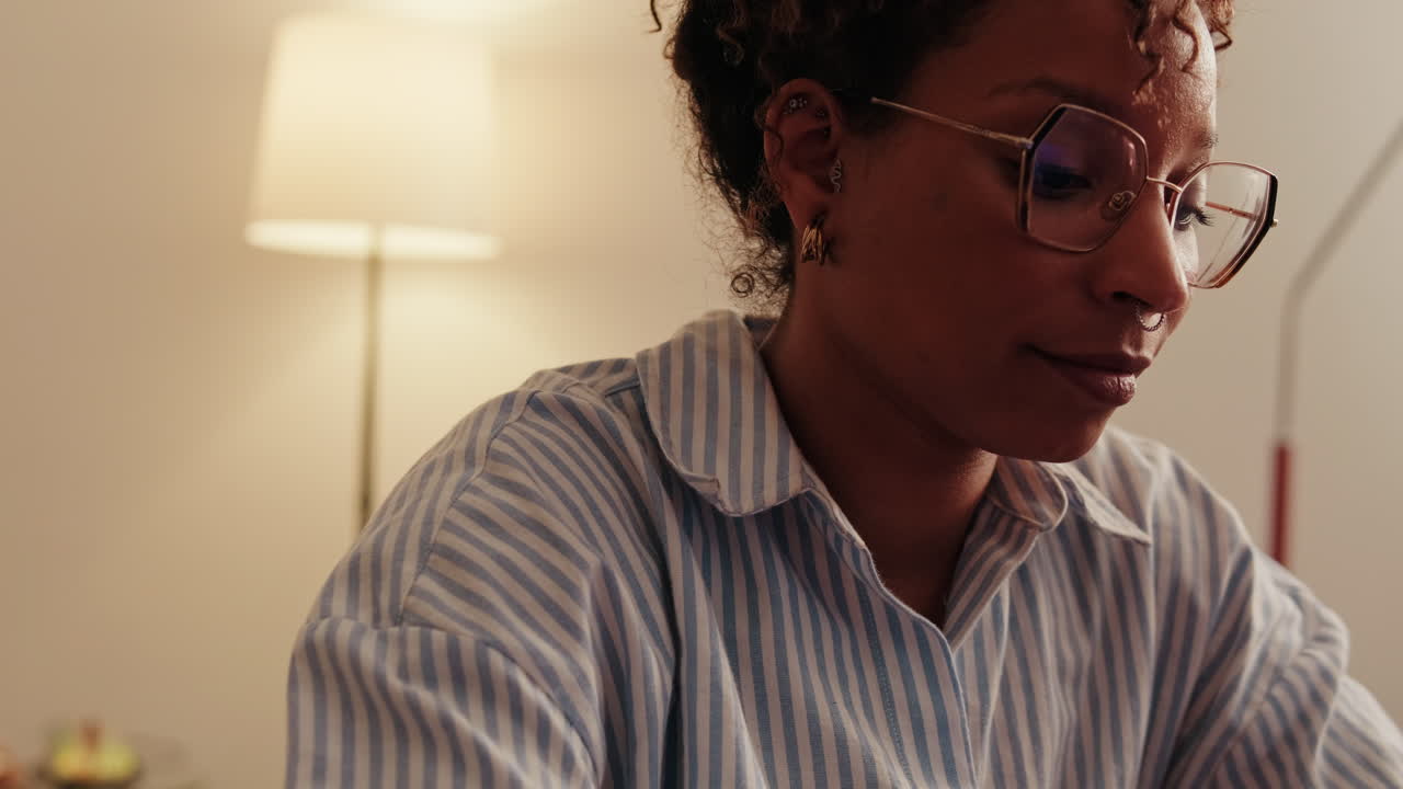 Woman Working From Home on Laptop. Side view