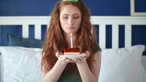 Zoom-out-video-of-sad-woman-blowing-a-birthday-candle