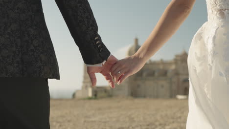 bride and groom holding hands, couple walking, wedding dress, church