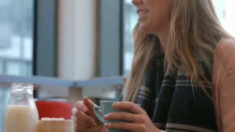 Pretty-friends-enjoying-coffee-in-cafe