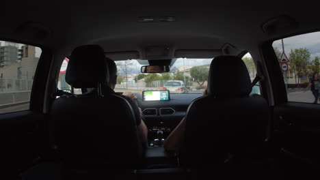 couple driving at night through city streets