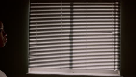 Woman-opening-curtain,-window-blinds