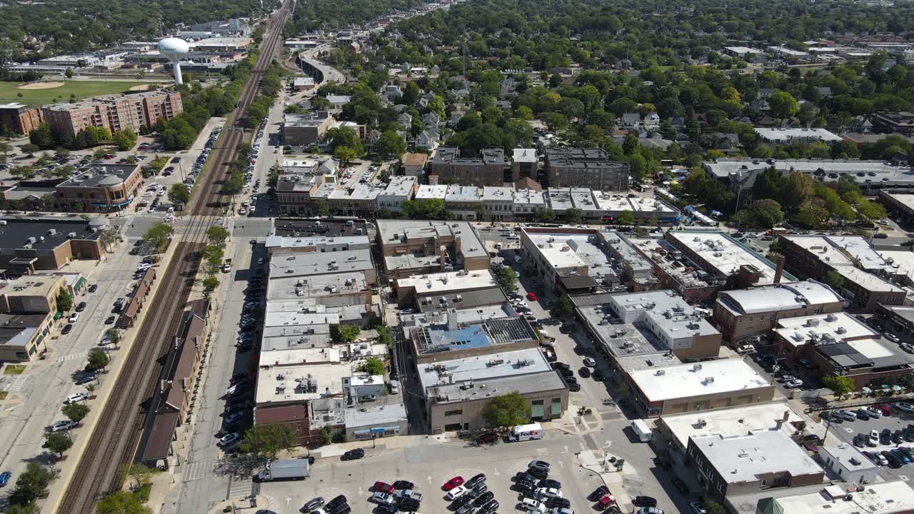 La Grange, IL on a sunny fall day, showcasing streets, buildings, and the suburban landscape With Downtown Chicago in Background. Crane Up Left Day E