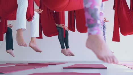 motion along women group practicing butterfly fly yoga pose