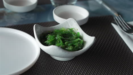 a bowl of wakame seaweed salad close up, typical dish in east asia