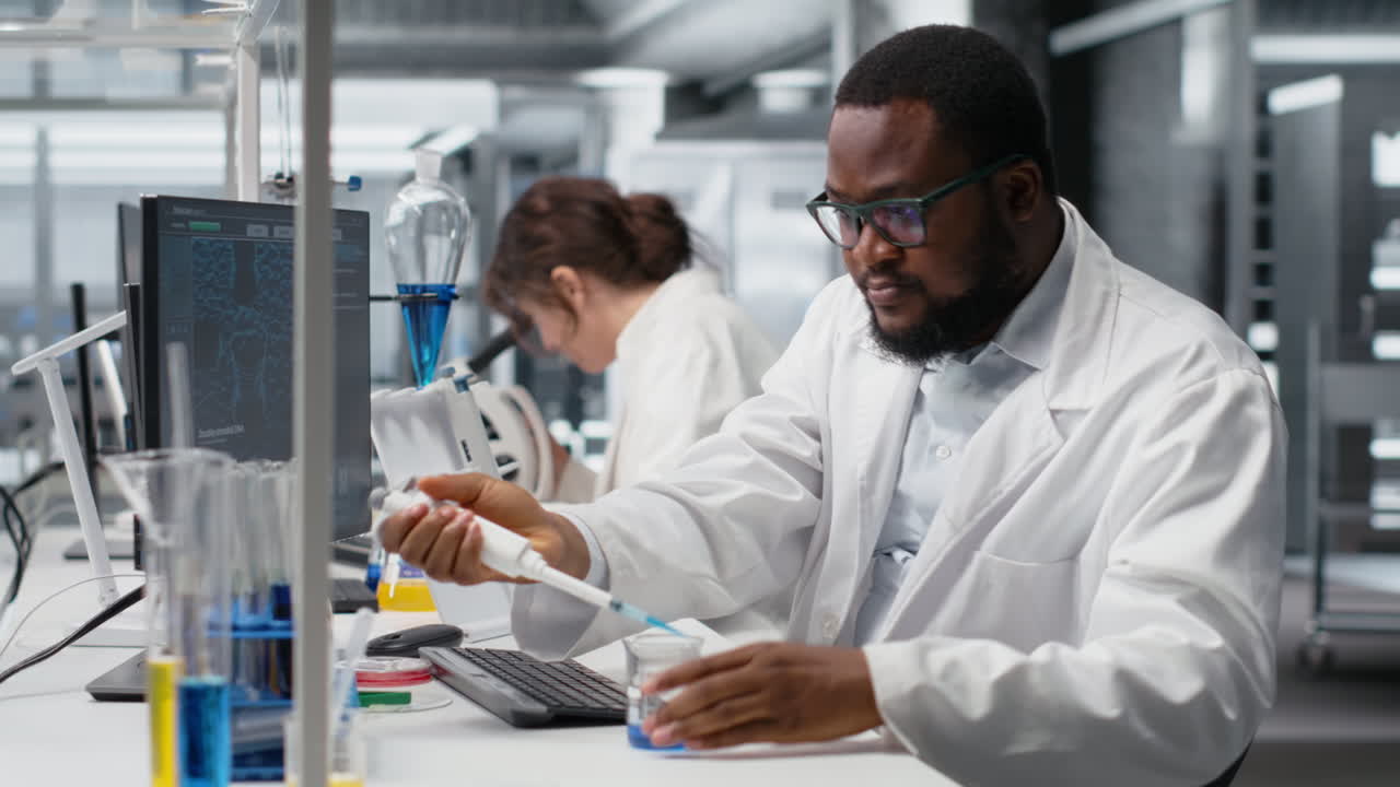 Vertical video Chemist uses pipette to transfer liquid into test tube at laboratory bench