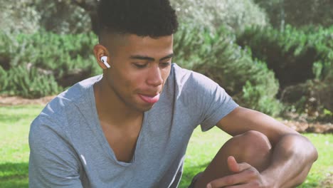 Black-sportsman-reading-messages-during-break