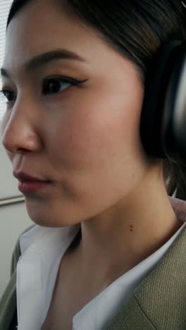 woman wearing headphones in an office setting