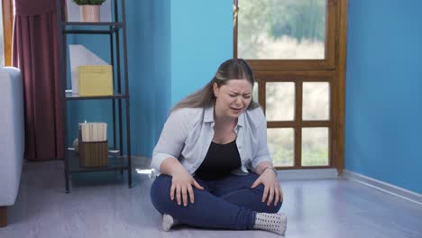 the young woman sitting by the wall is angry with herself.