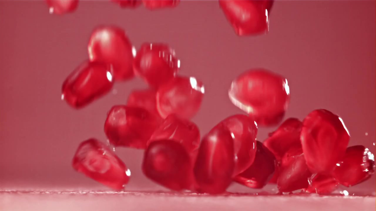Fresh Pomegranate Seeds Falling in Slow Motion