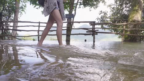 legs tourist woman walking in the river, slow motion